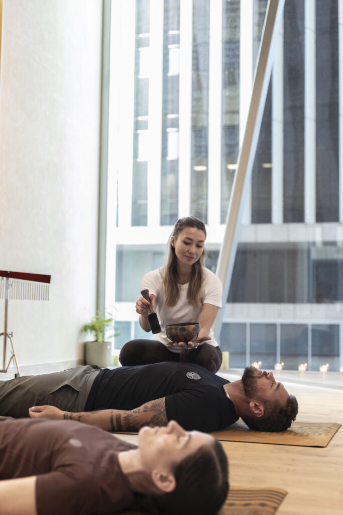 men and women in a sound bath meditation class.